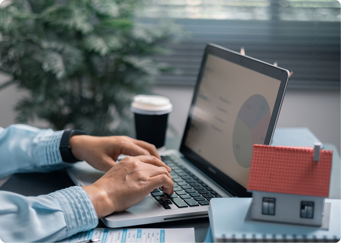 Person using laptop, analyzing data graphs